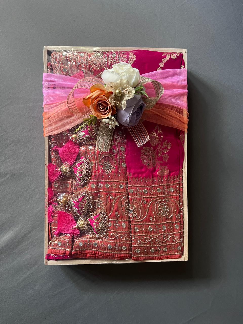 Embellished burgundy saree with intricate gold work and floral decoration